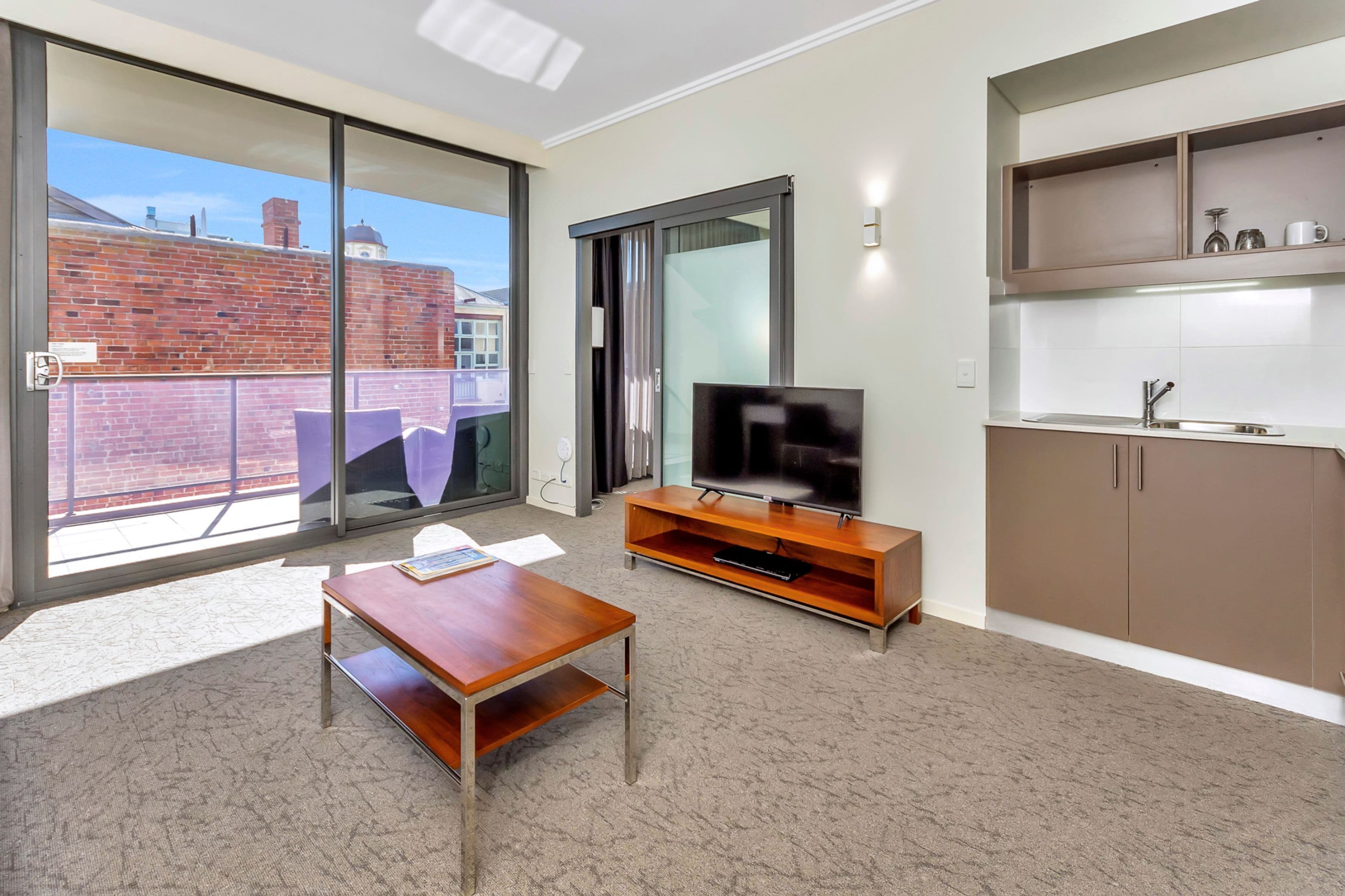 new haus suite with balcony | living area | 43-inch smart tv with digital channels, tv