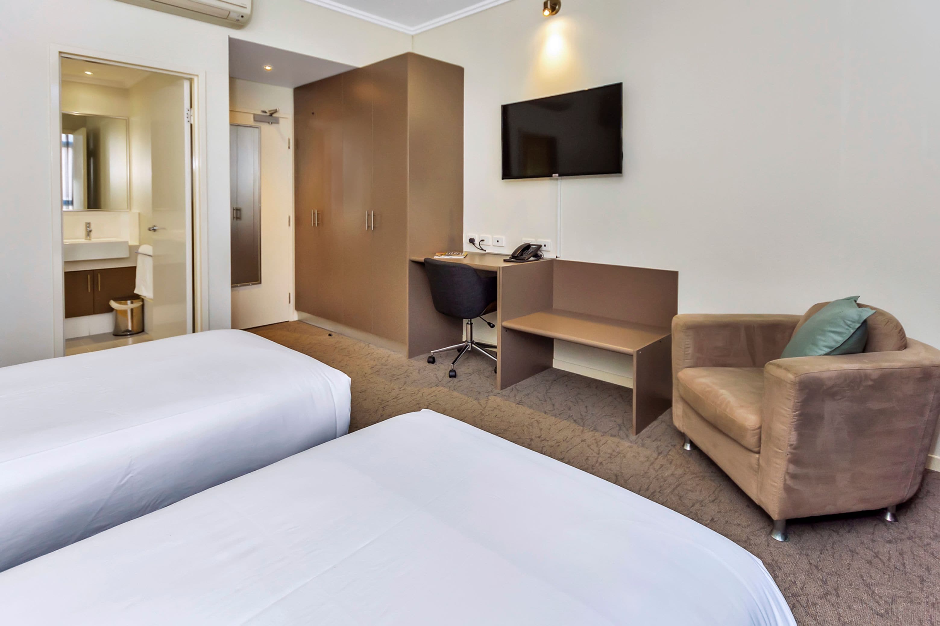 new haus room | pillow-top beds, desk, laptop workspace, blackout curtains