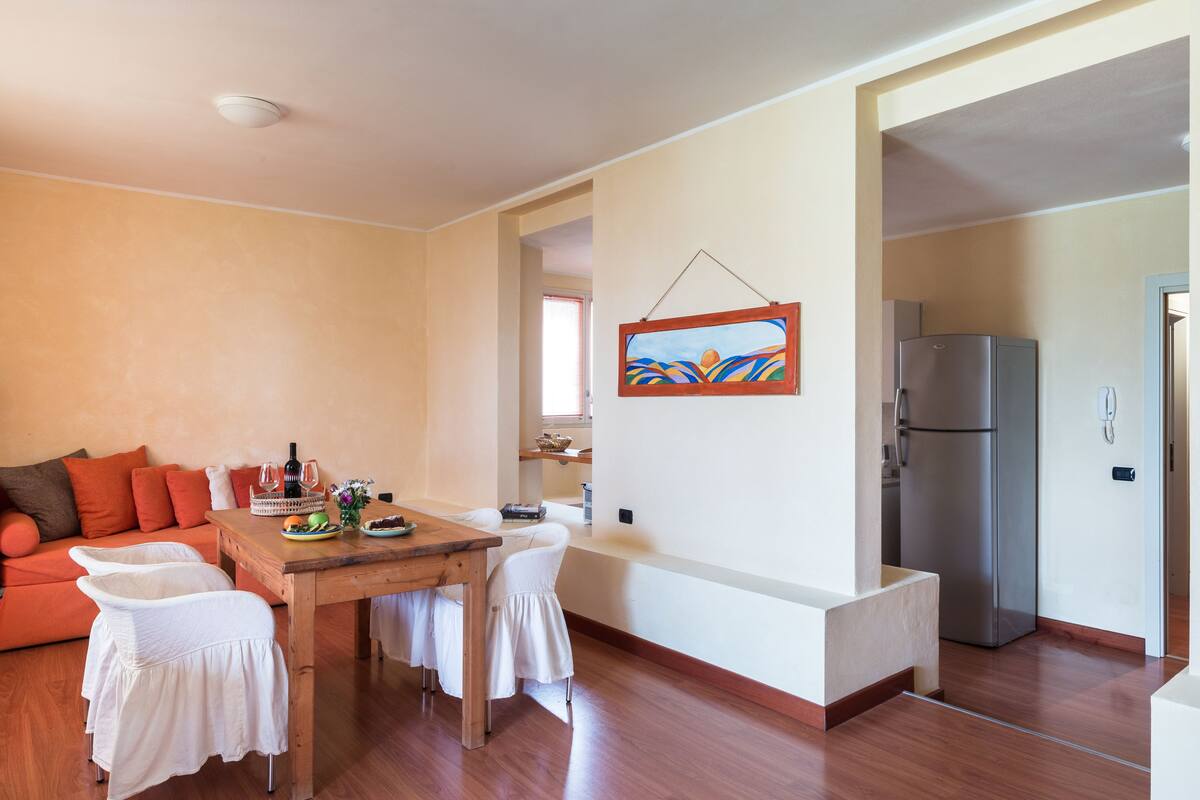 A modern living space with a dining area, a kitchen, and a living room.