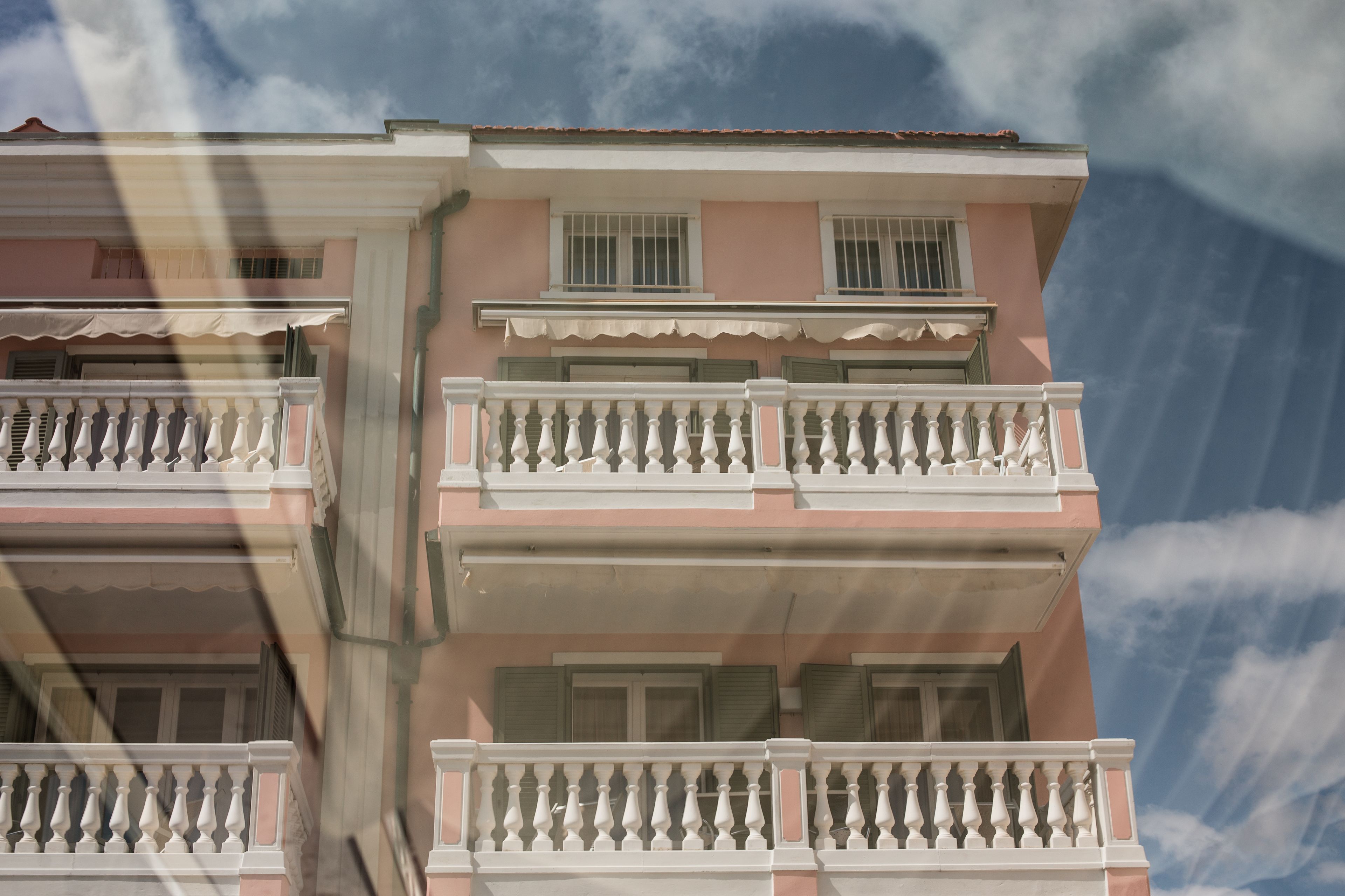 A multi-story building with balconies and windows.