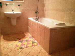 A bathroom with a sink, a bathtub, and a shower.