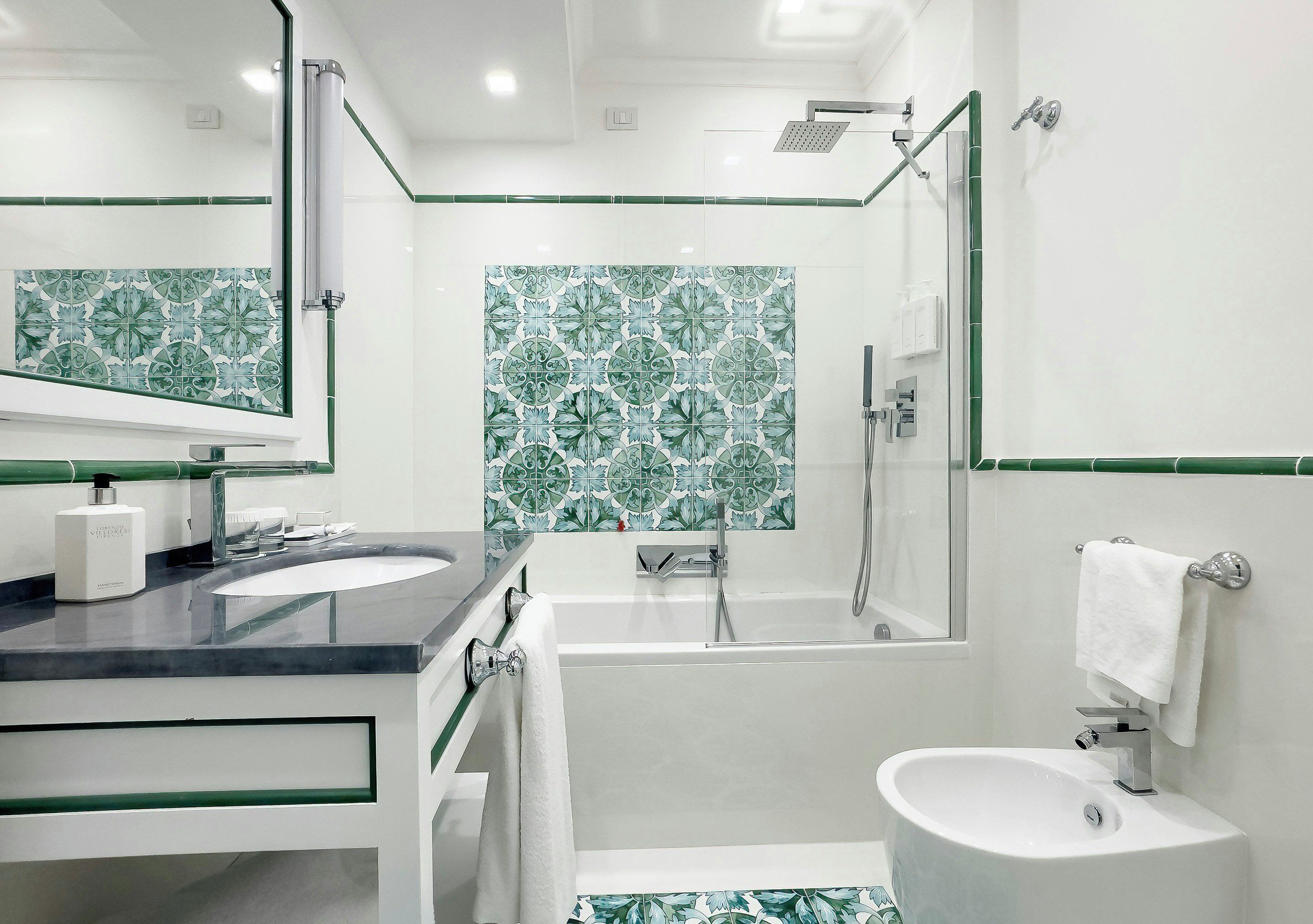A modern bathroom with a bathtub, a sink, a toilet, and a shower.