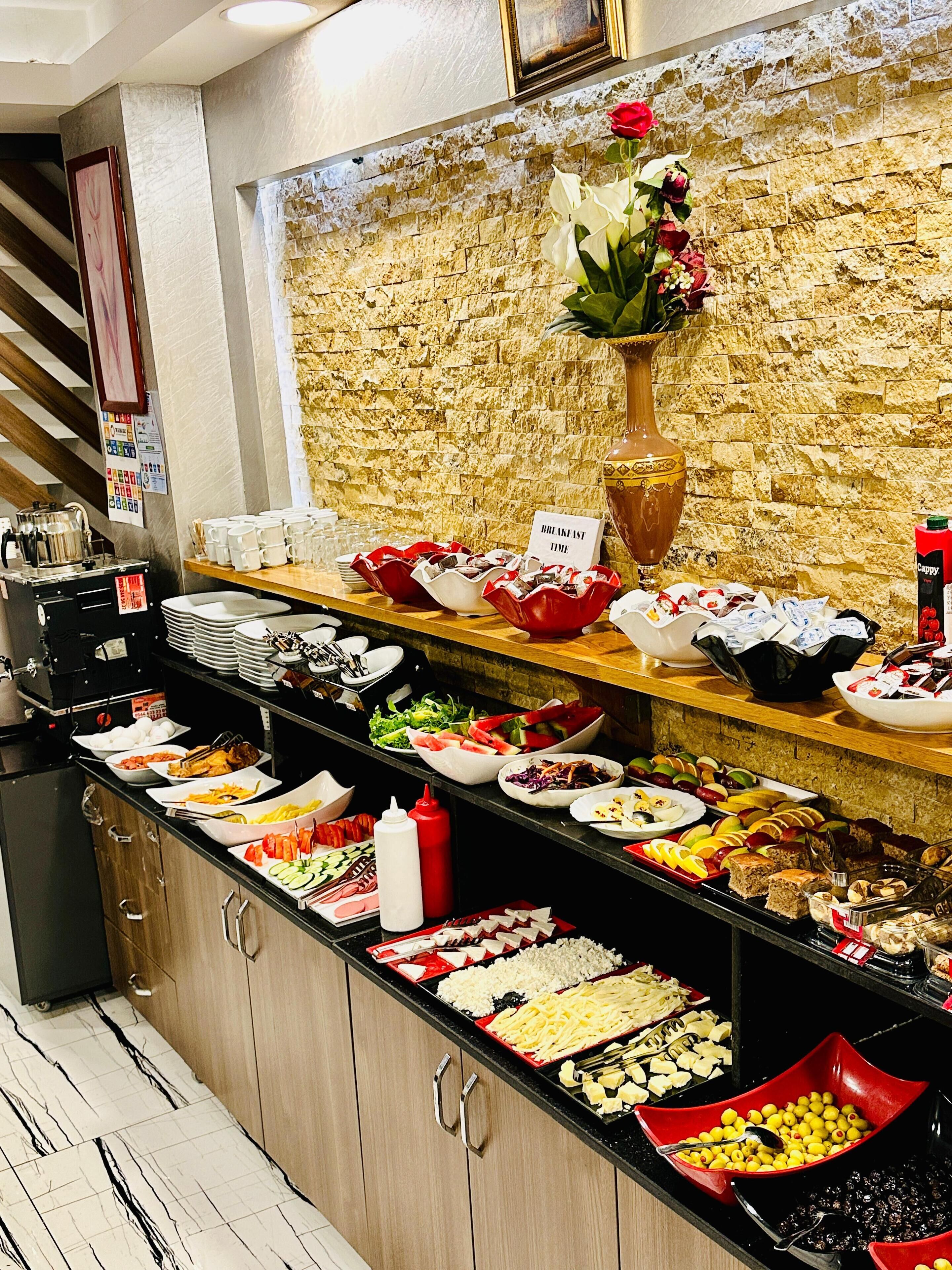 A buffet with various food items and a clock indicating the time.