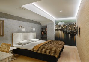 A modern bedroom with a cityscape mural, a large bed, and a desk. - Skanstulls Boutique Hostel (Stockholm)