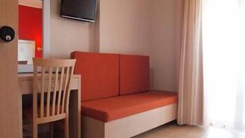 Economy Double or Twin Room | Living area | TV