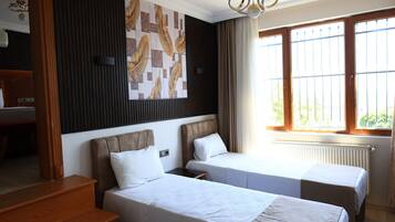 Family Quadruple Room | Minibar, desk, blackout drapes, soundproofing