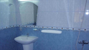 A bathroom with a sink, mirror, and shower. - Kirios (Nessebar)