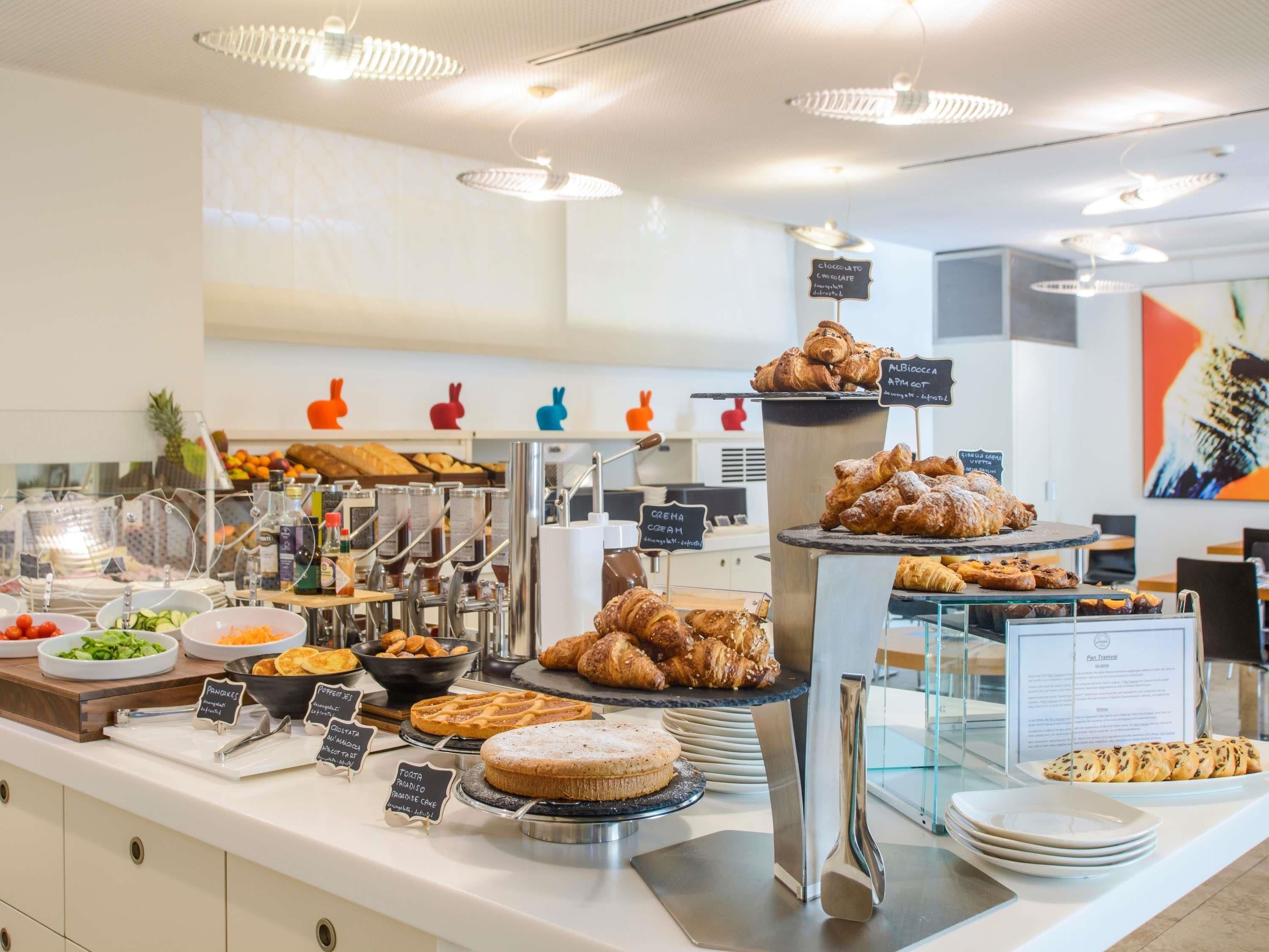 A buffet with various food items and a sign indicating a chocolate option.