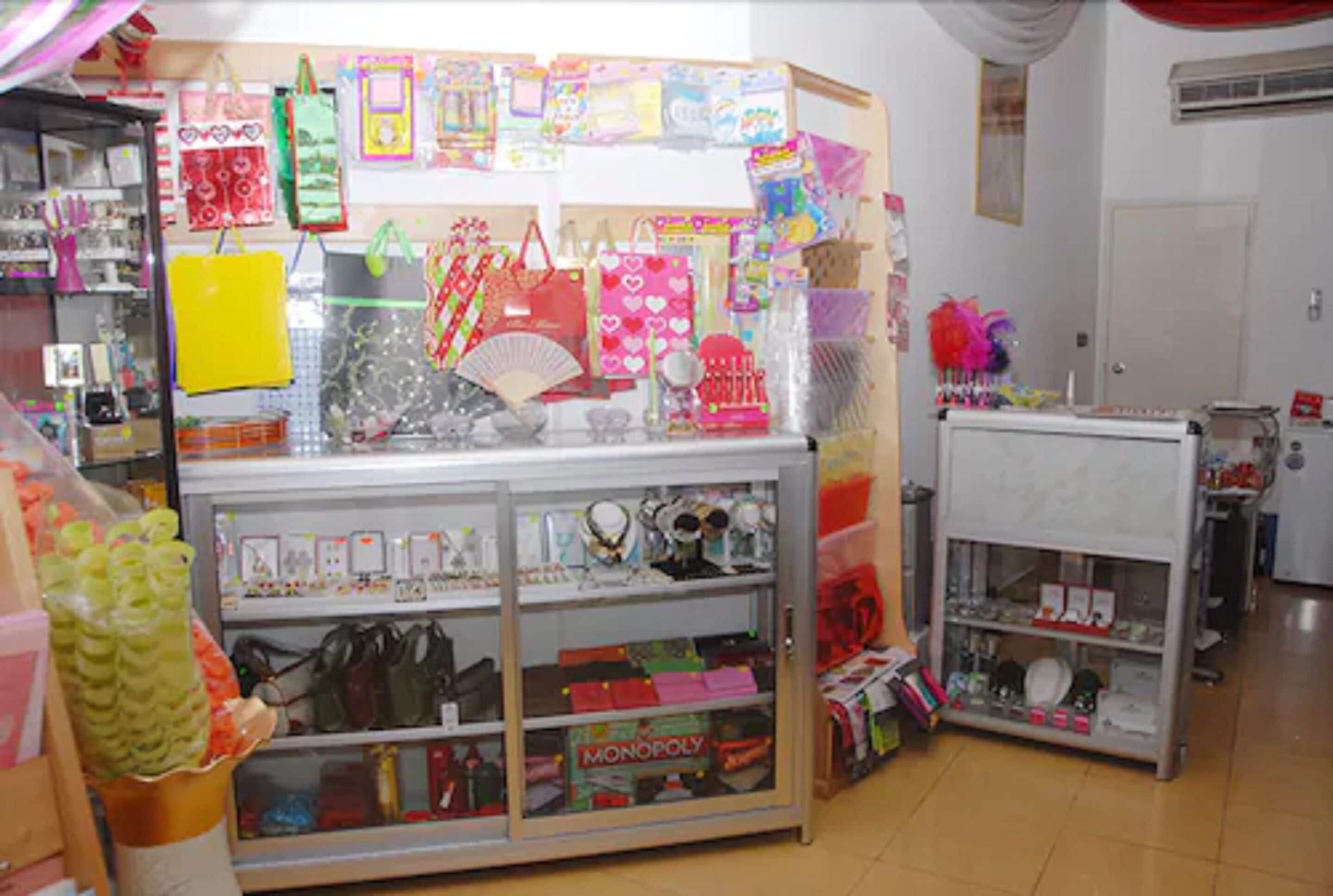 A store with shelves of various items including books, bags, and board games.