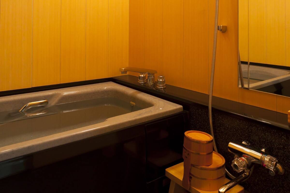 A bathroom with a bathtub, a sink, and a shower.