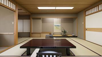 A traditional Japanese meeting room with tatami flooring, a low table, and a single chair.
