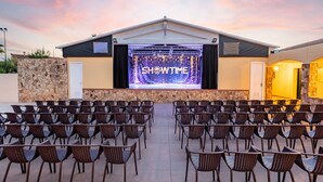 An outdoor amphitheater with rows of chairs facing a stage with 'SHOWTIME' displayed. - Sentido Tirreno Resort (Orosei)