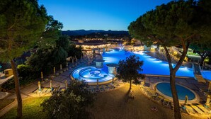 A large outdoor swimming pool with multiple levels and a surrounding deck area. - Sentido Tirreno Resort (Orosei)