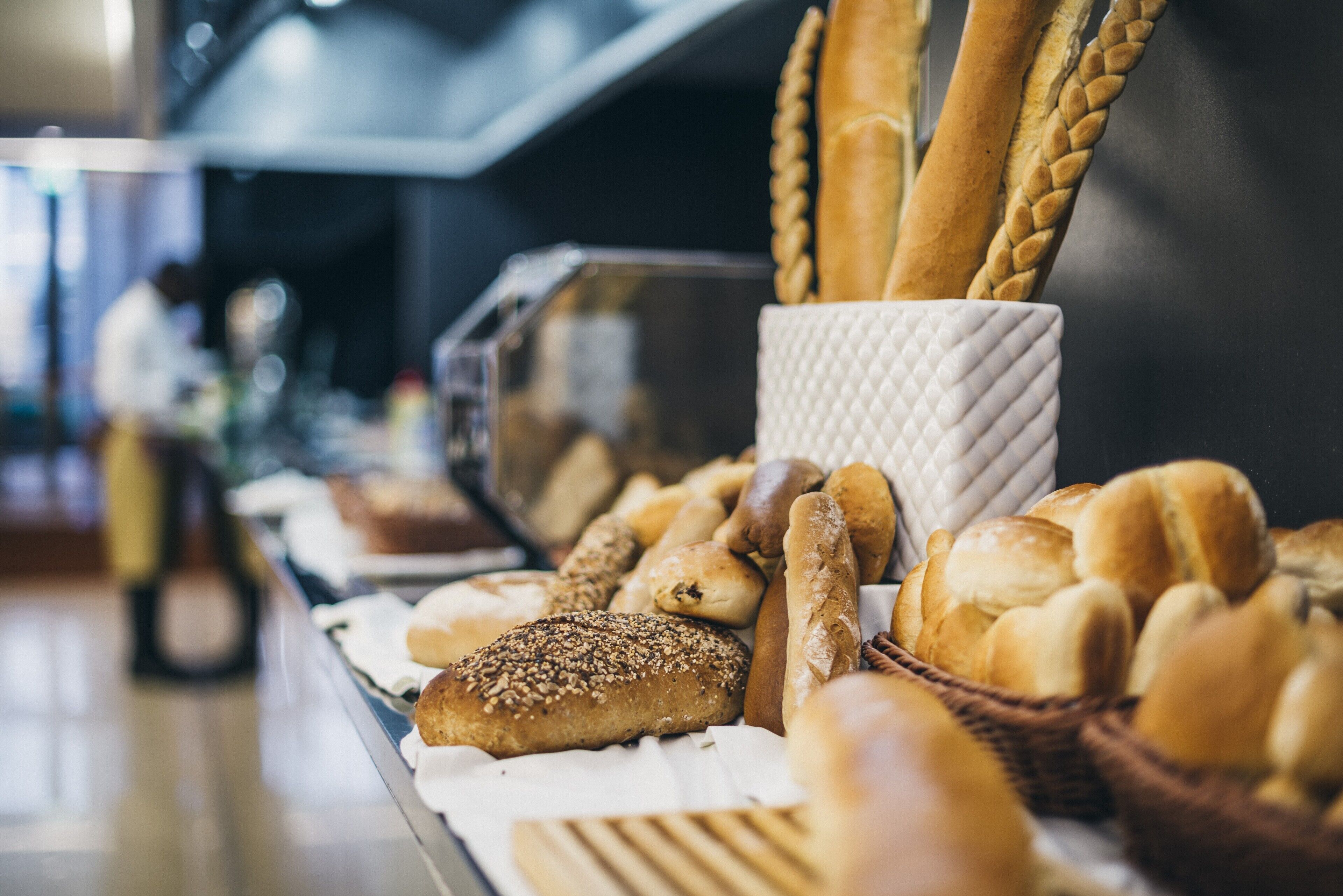 A variety of breads and pastries displayed in a bakery setting.