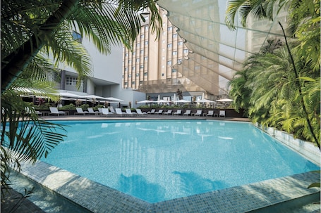 Una piscina al aire libre, sillones reclinables de piscina. Hotel Trópico