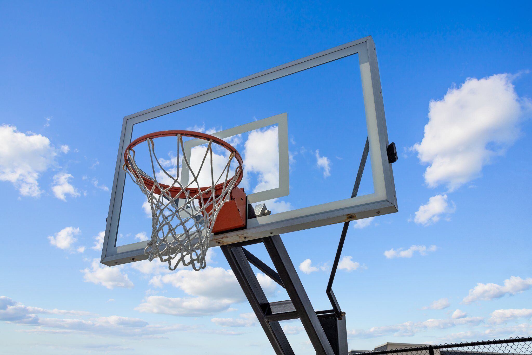A basketball hoop against a clear sky.