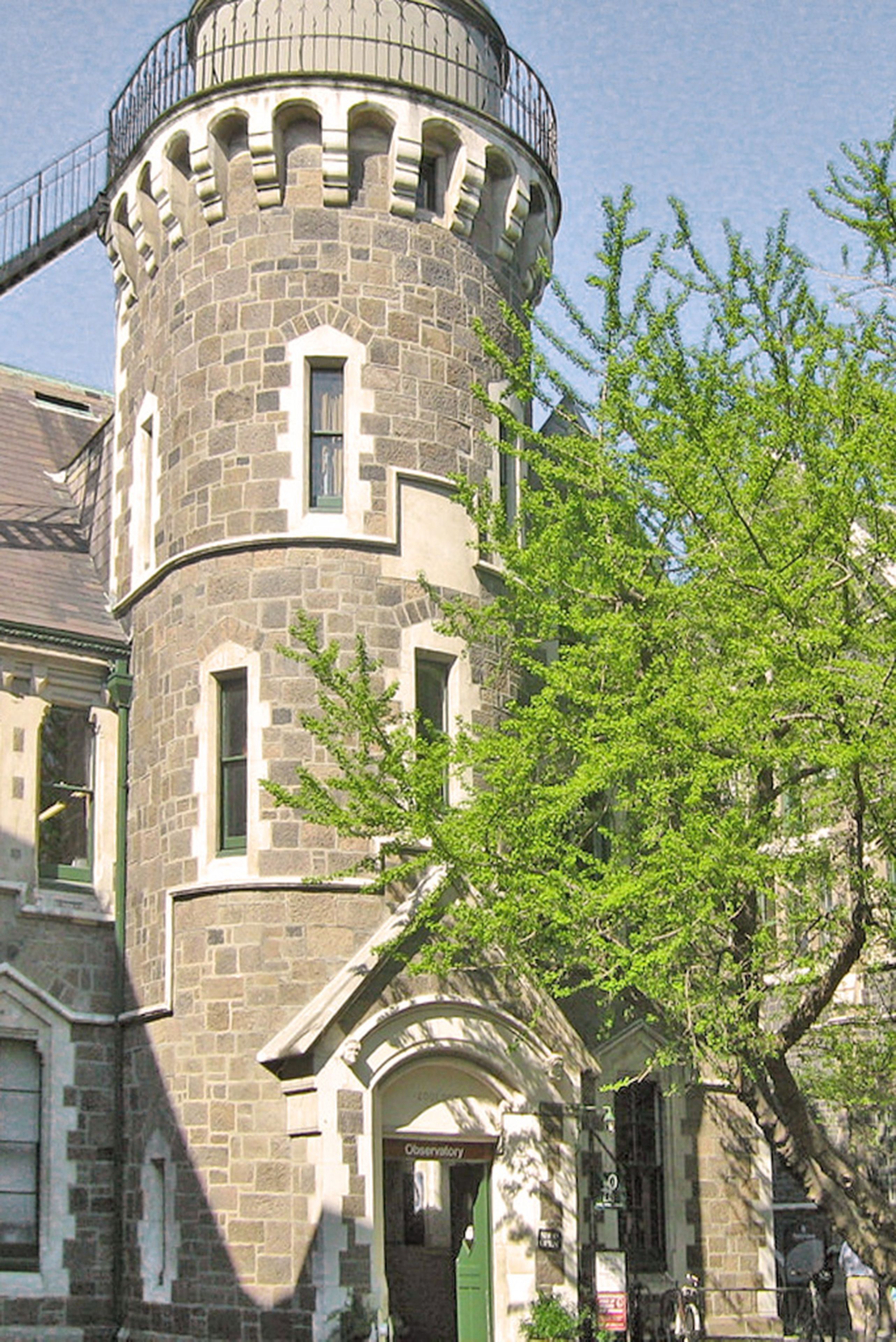 A stone tower with arched windows and a balcony.