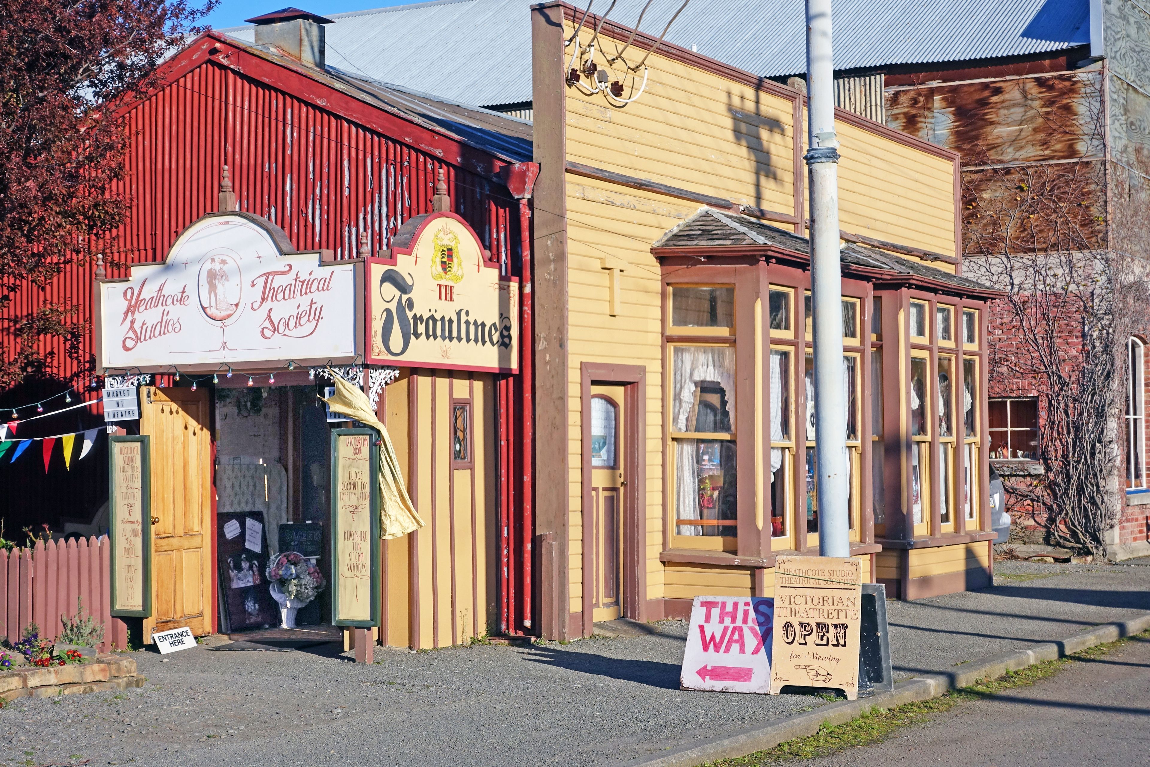 A building with signs for 'Heathcote Theatrical Society' and 'The Scrullines'.