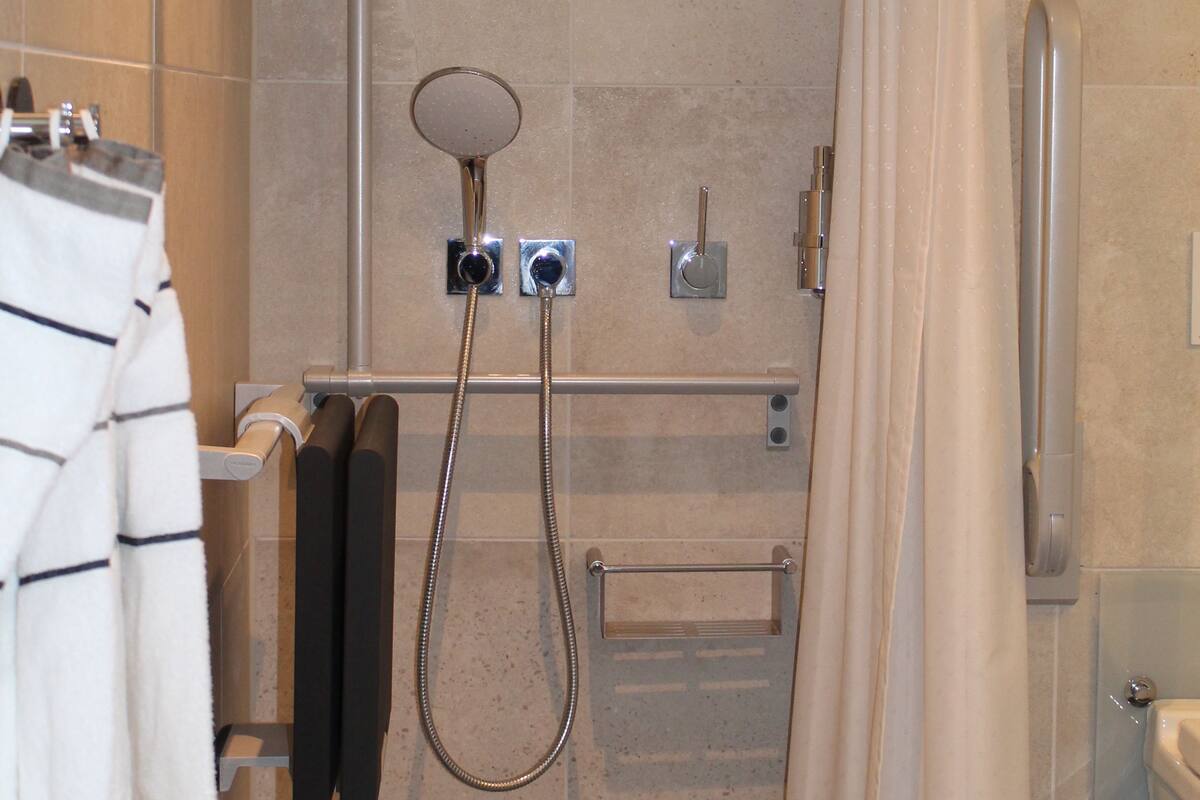 shower, hair dryer, towels, soap