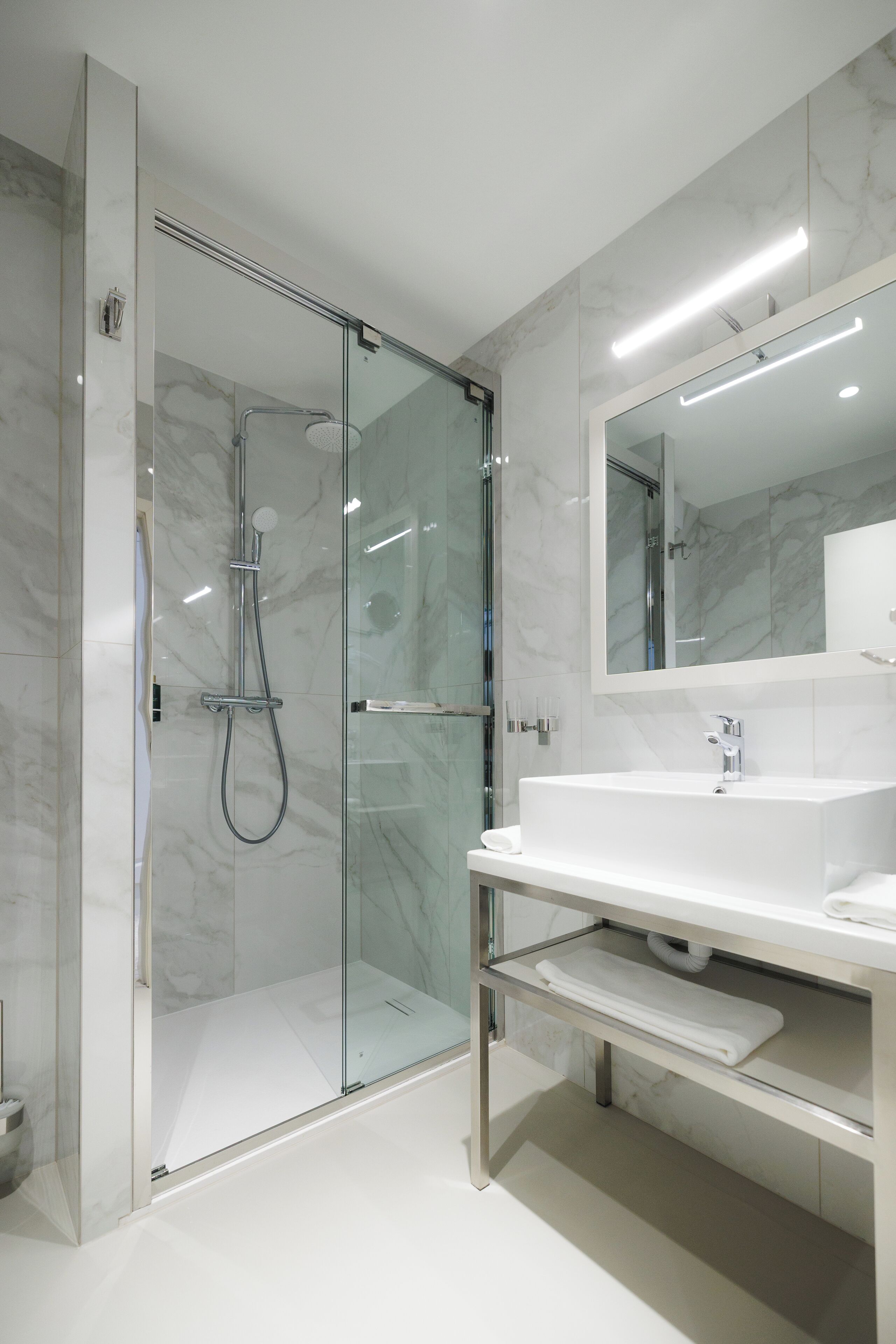 superior double room | bathroom | shower, hair dryer, slippers, towels