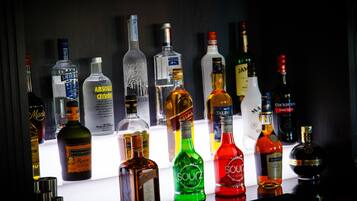 A variety of liquor bottles displayed on a bar counter.
