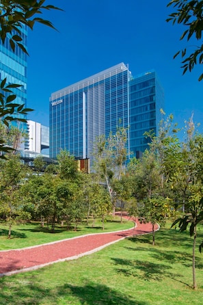 Guests can enjoy a tranquil outdoor space with a well-manicured lawn and a scenic view of the interior.