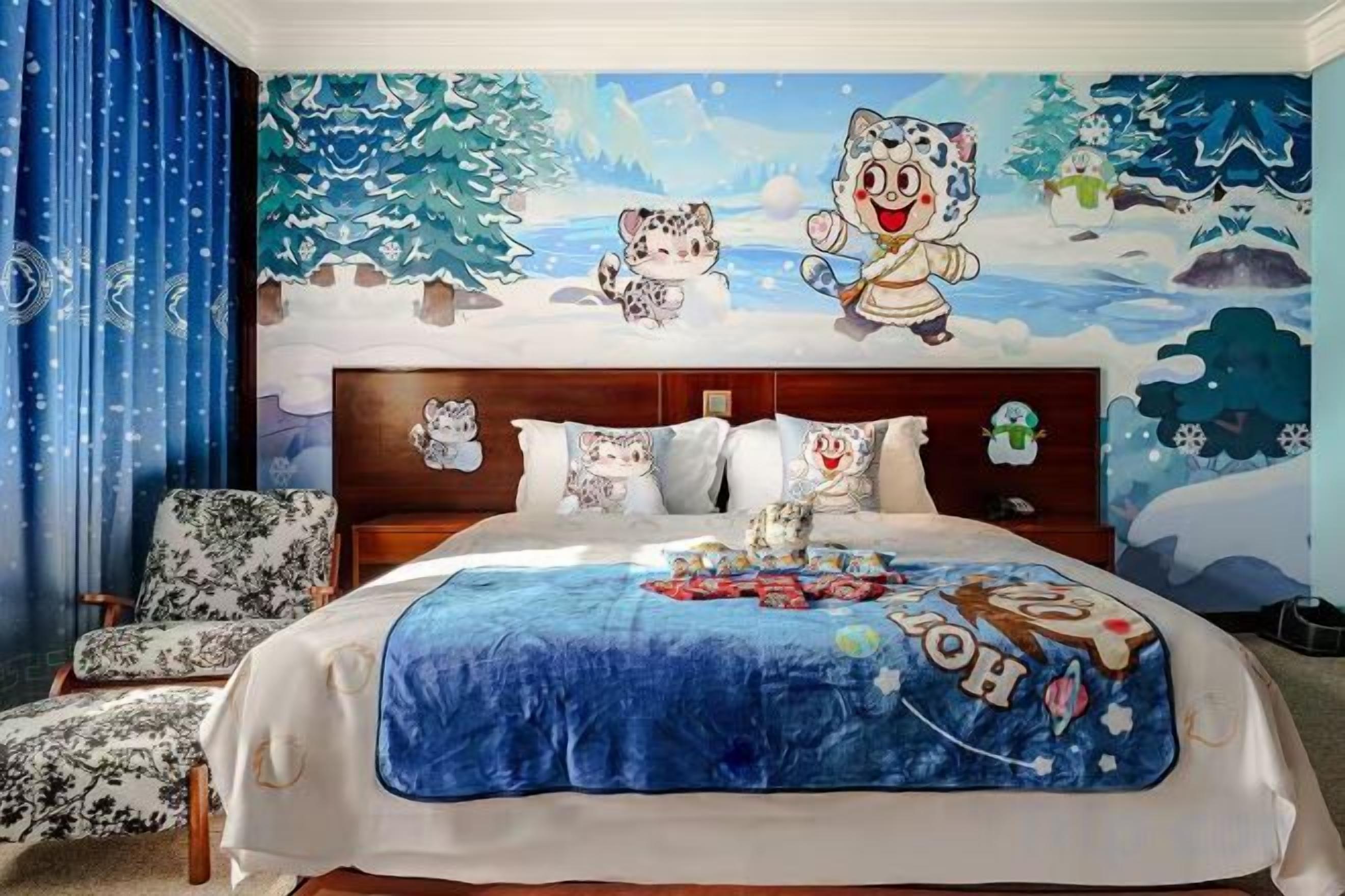 A bedroom with a large bed, a headboard with a Christmas-themed mural, and a blue blanket.