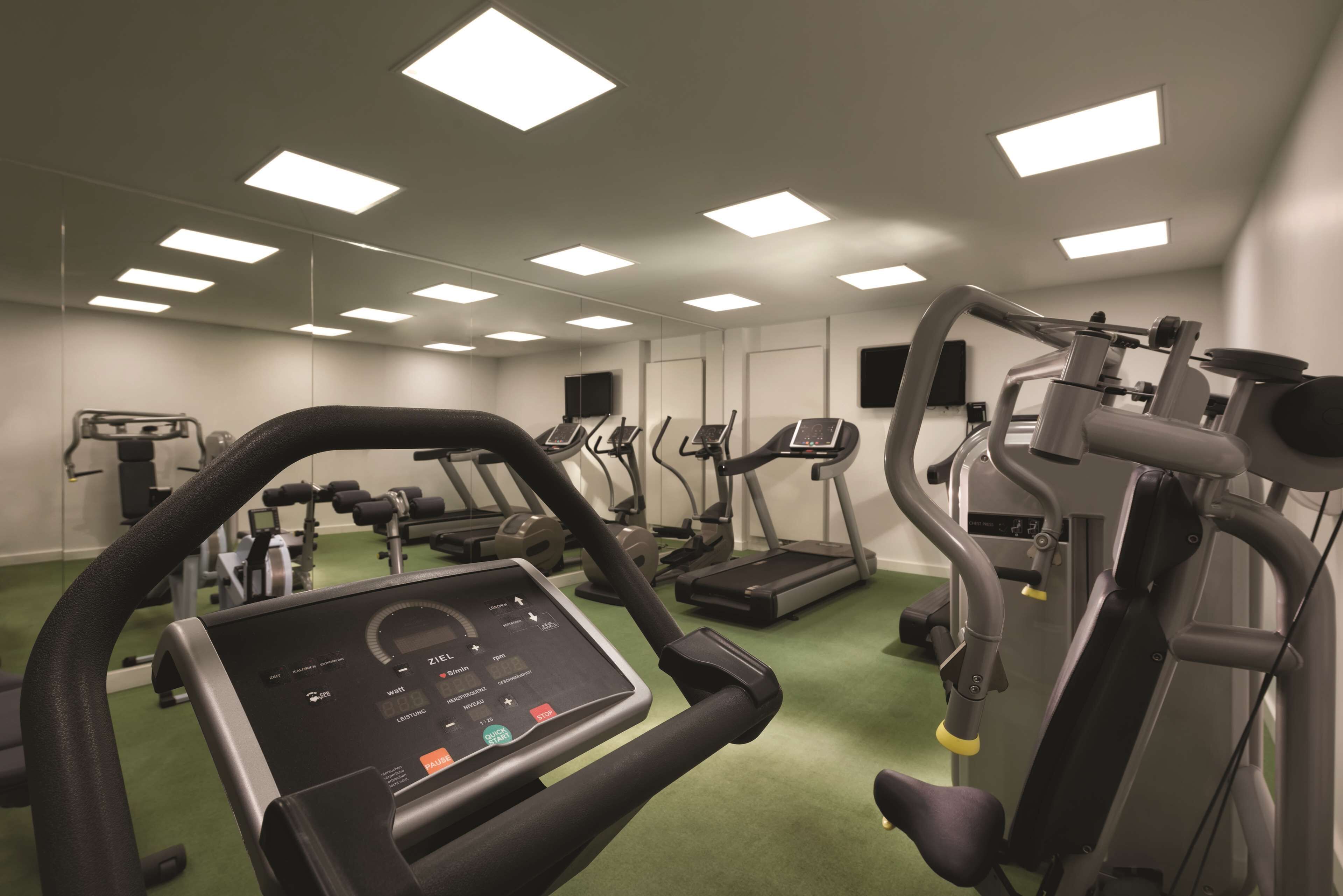 A gym with treadmills, elliptical machines, and weight equipment.