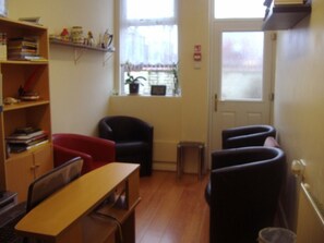 A room with a desk, chairs, a bookshelf, and a window with a view. - The Address (Blackpool)