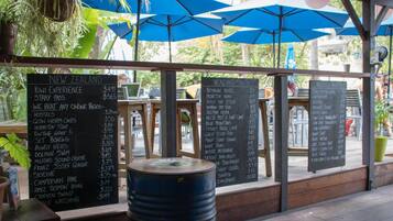 A menu board with various food and drink options and prices.