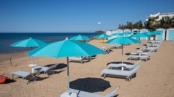 Privatstrand, weißer Sandstrand, Liegestühle, Sonnenschirme