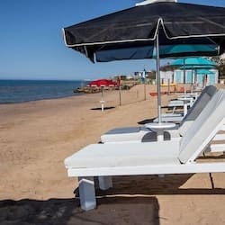 Private beach, white sand, sun loungers, beach umbrellas