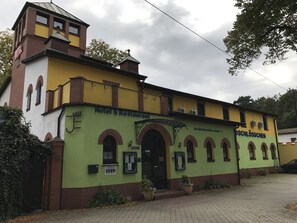 A building with a sign reading "Hotel & Restaurant" and "Am Waldschlössen 3" indicating its location. - Hotel Waldschlösschen (Mittenwalde)