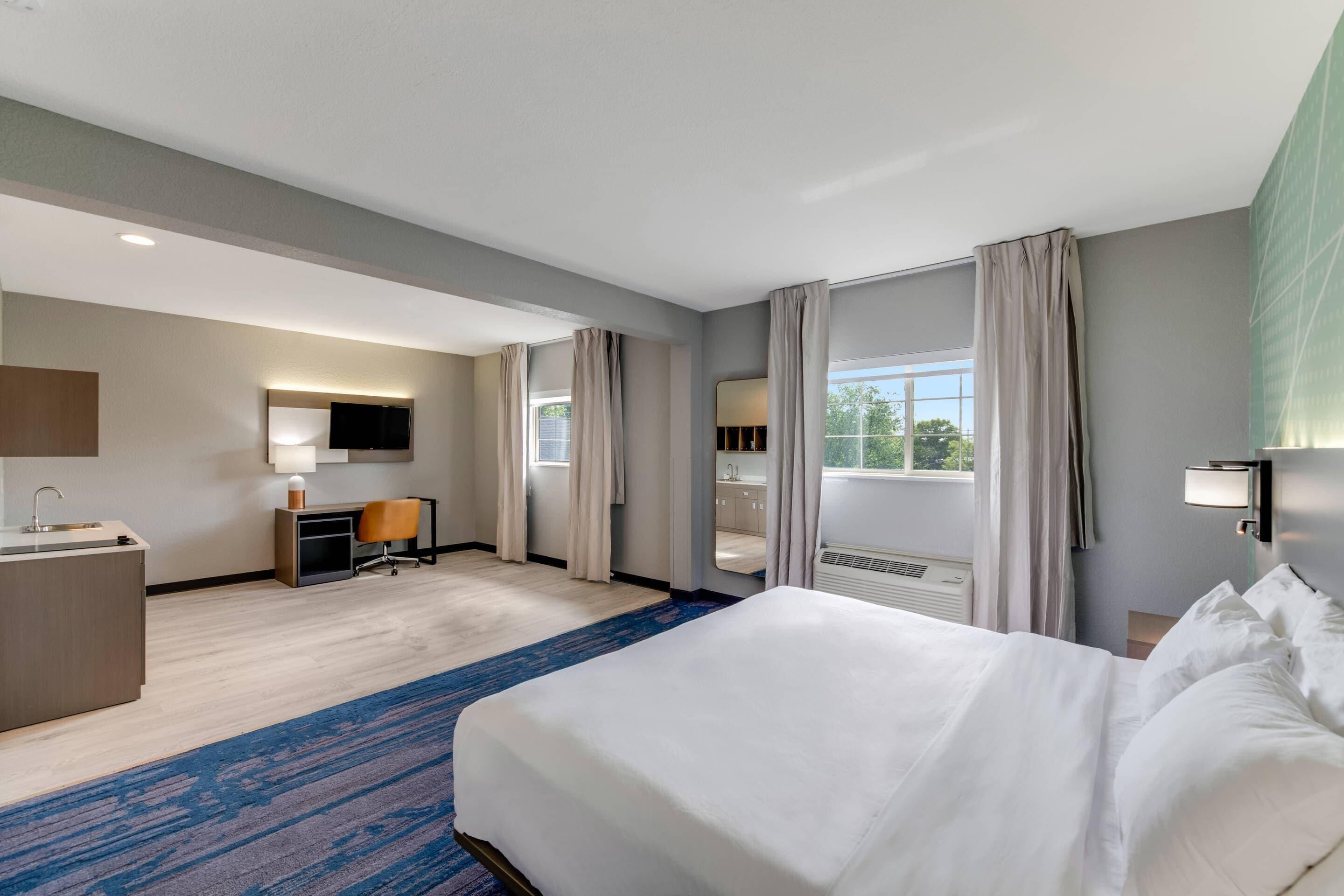 Desk, laptop workspace, blackout drapes, iron/ironing board