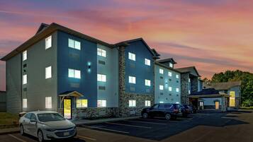 A multi-story hotel with a stone facade and multiple windows.