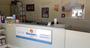 A reception desk with a sign reading "Discovery Parks Welcome to Moama West." - Discovery Parks - Moama West (Moama)