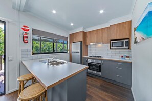 Deluxe 2 Bedroom Cabin - Water Park View | Private kitchen | Fridge, microwave, stovetop, coffee/tea maker