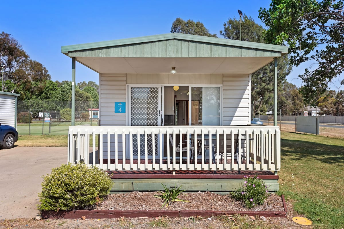 A small, single-story building with a porch and a covered entrance.