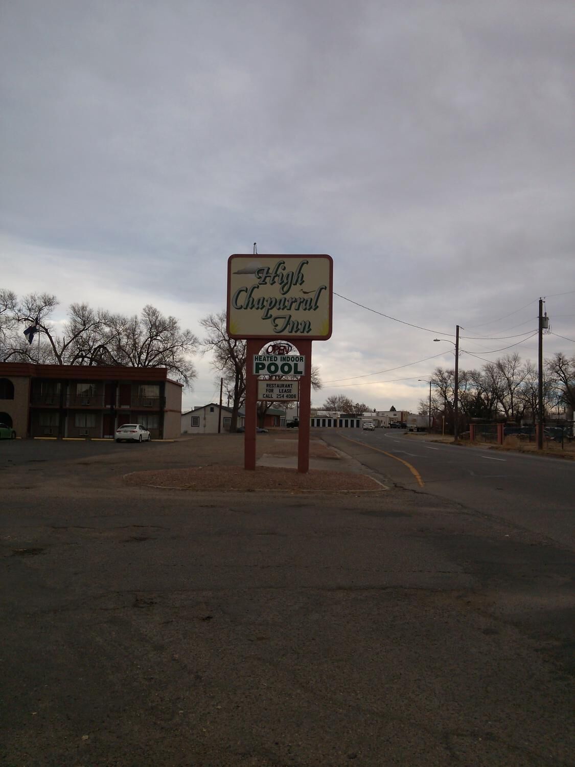A sign for the High Chaparral Inn, indicating it is a heated indoor pool restaurant for lease.