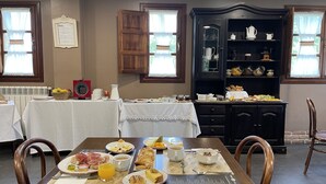A breakfast buffet with various food items and a coffee station. - Casona de Cefontes (Gijon)