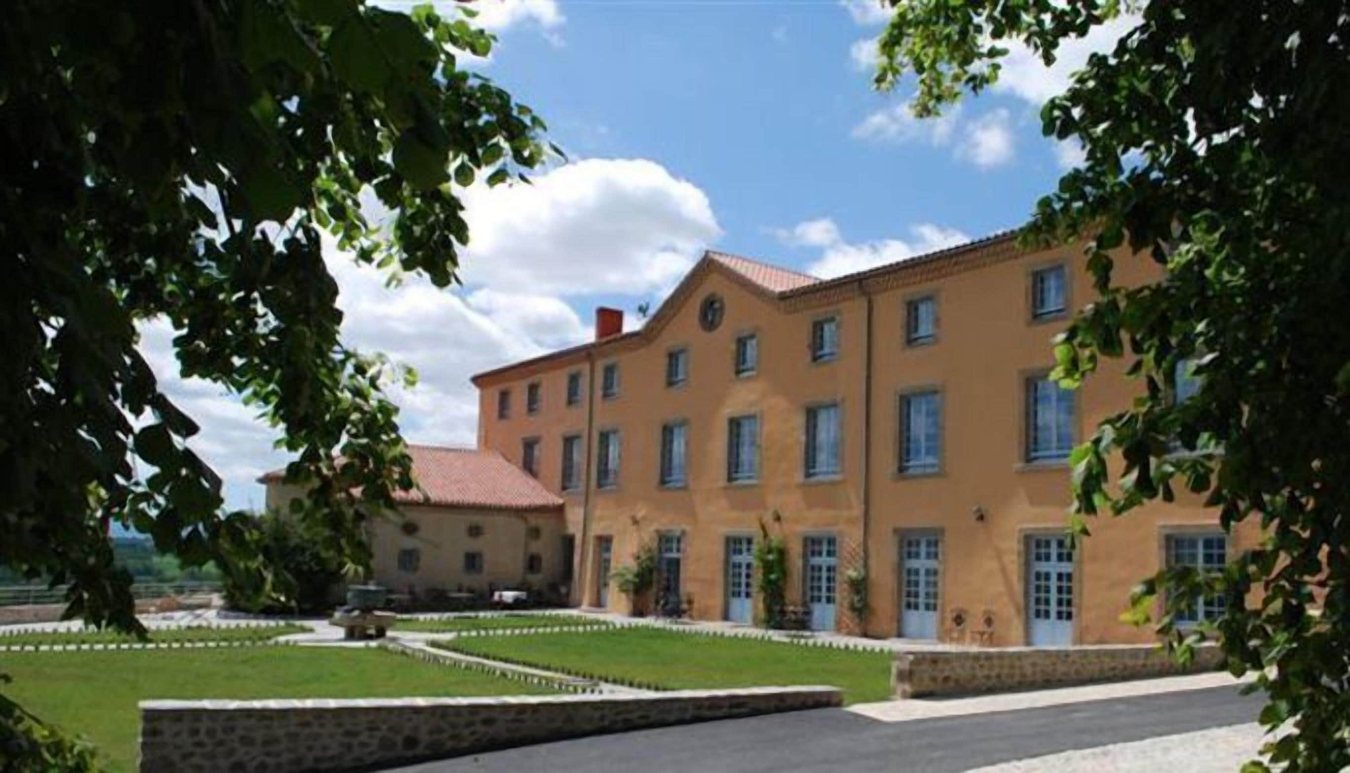 A large, multi-story building with a symmetrical facade, featuring evenly spaced windows and a central entrance.