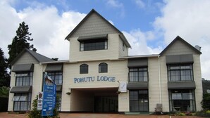 A two-story building with the sign "POHUTU LODGE" on the front. - Pohutu Lodge Motel (Rotorua)