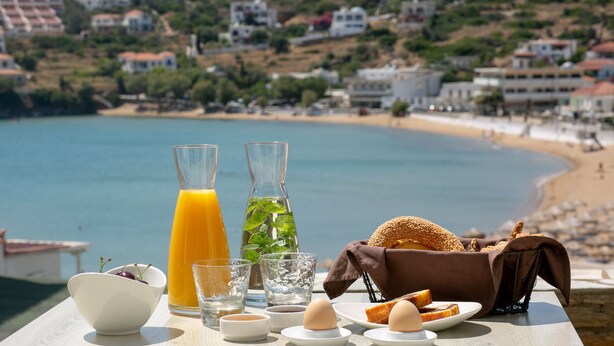 Desayuno con vista a la playa y casas al fondo.