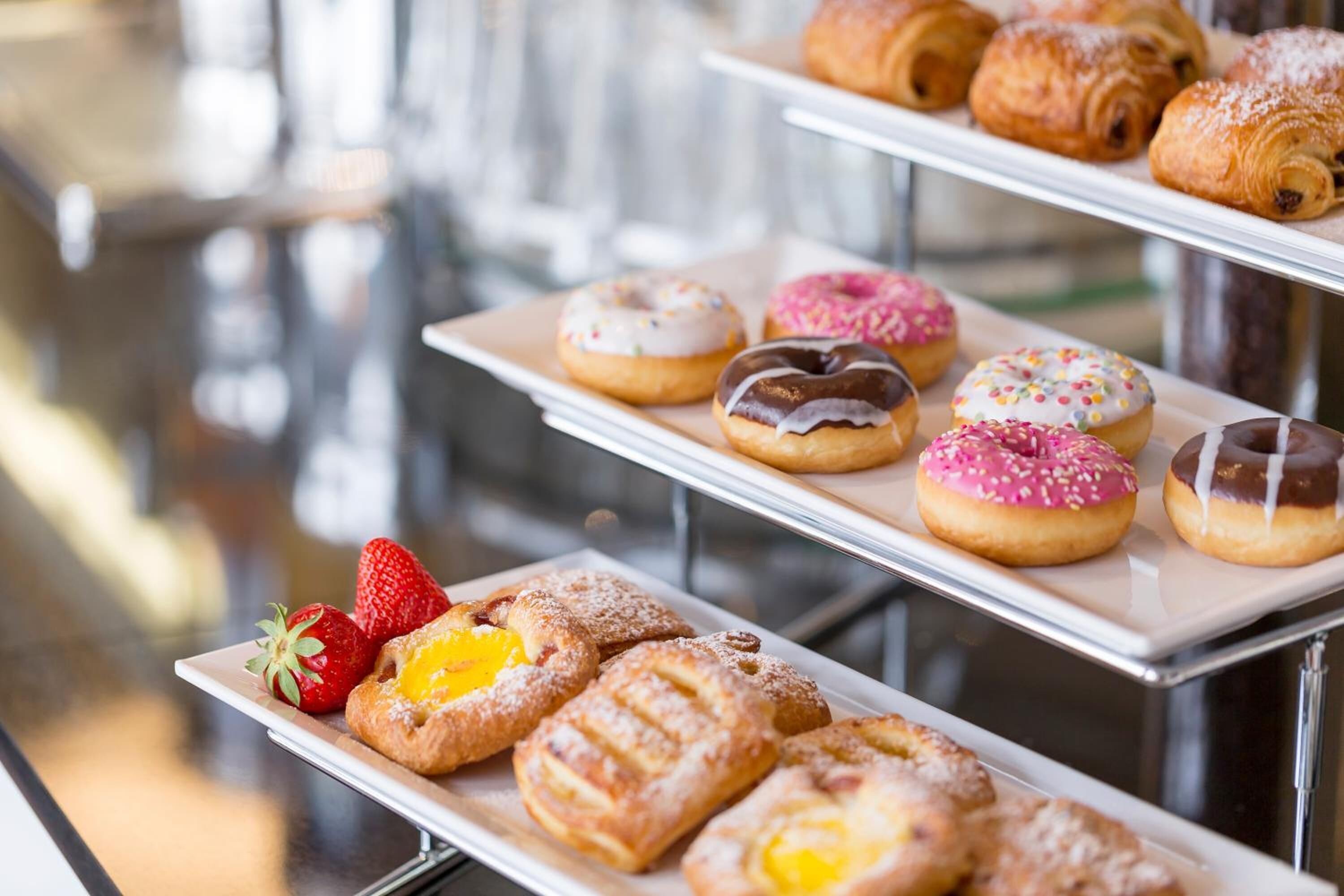 A display of various pastries and desserts on trays.
