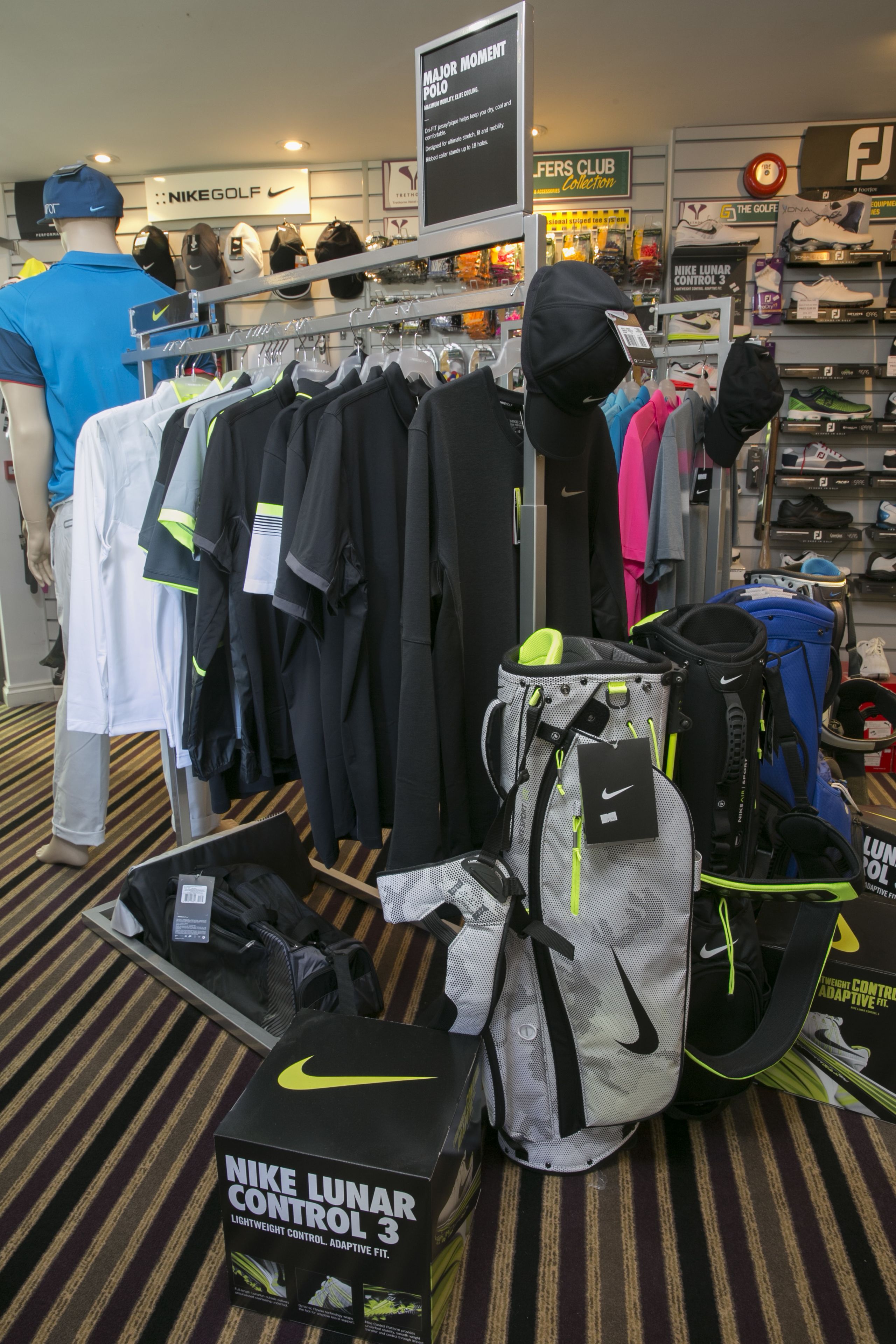 A Nike Lunar Control 3 shoe display with various athletic wear and accessories.