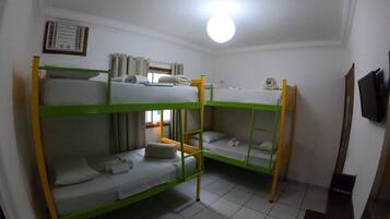 A bunk bed room with a ceiling fan, a window with curtains, and a wall-mounted thermostat.