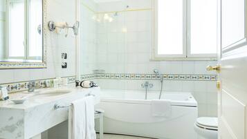 A bathroom with a bathtub, toilet, and sink.