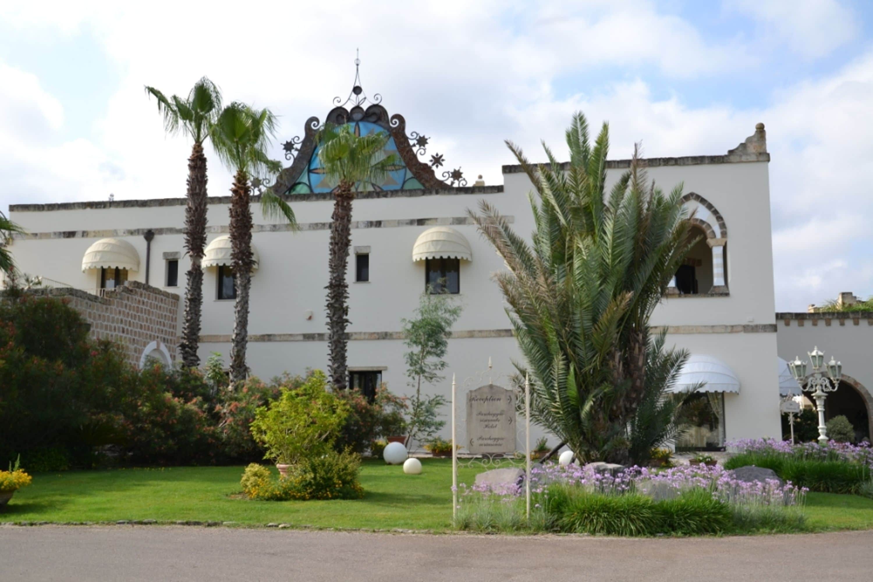 A building with a white facade, arched windows, and a decorative dome.