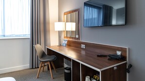 A hotel room with a wooden desk, a chair, a large mirror, a flat-screen TV, and a window with curtains. - Heeton Concept Hotel City Centre Liverpool (Liverpool)