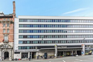 A multi-story hotel with a modern facade, a prominent entrance, and a sign for 'James Street.'